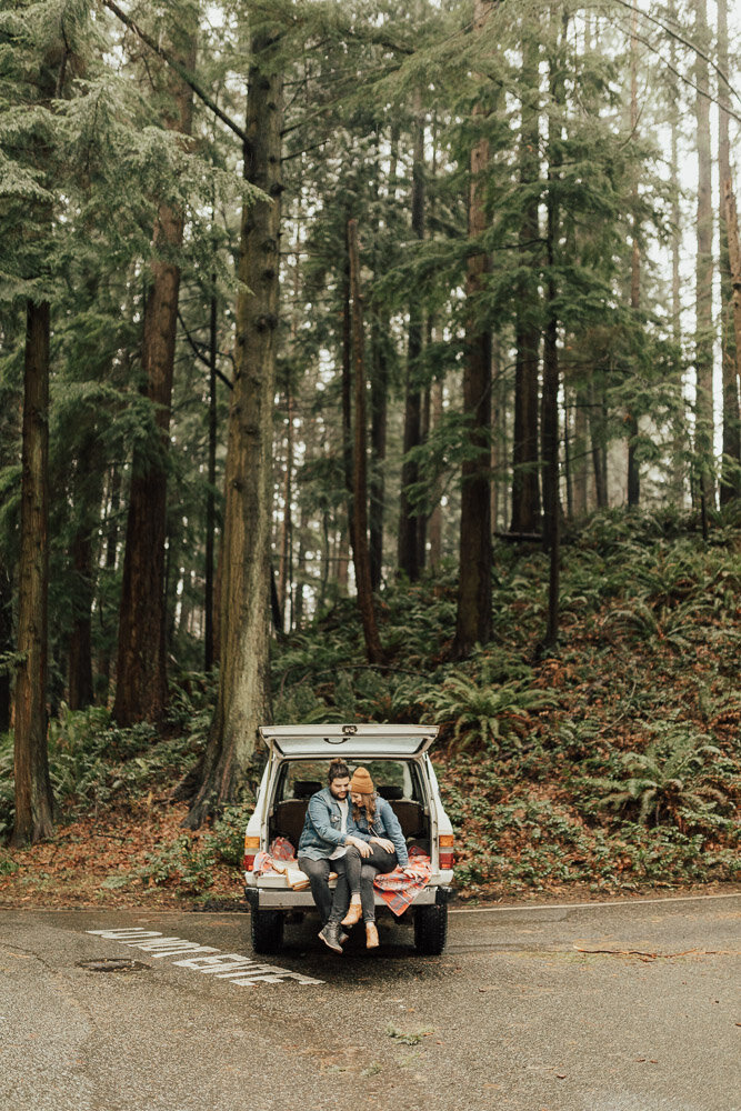 engagement photoshoot couple in jeep romantic forest washington