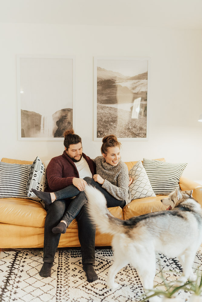 couple in home photoshoot with dog