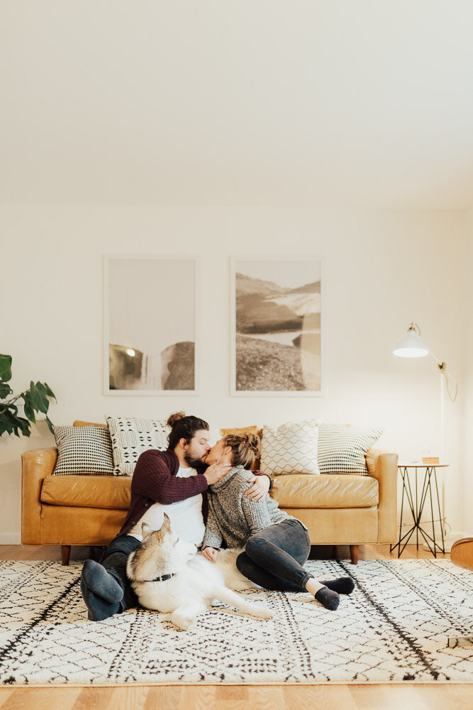 couple kissing with husky in home photoshoot