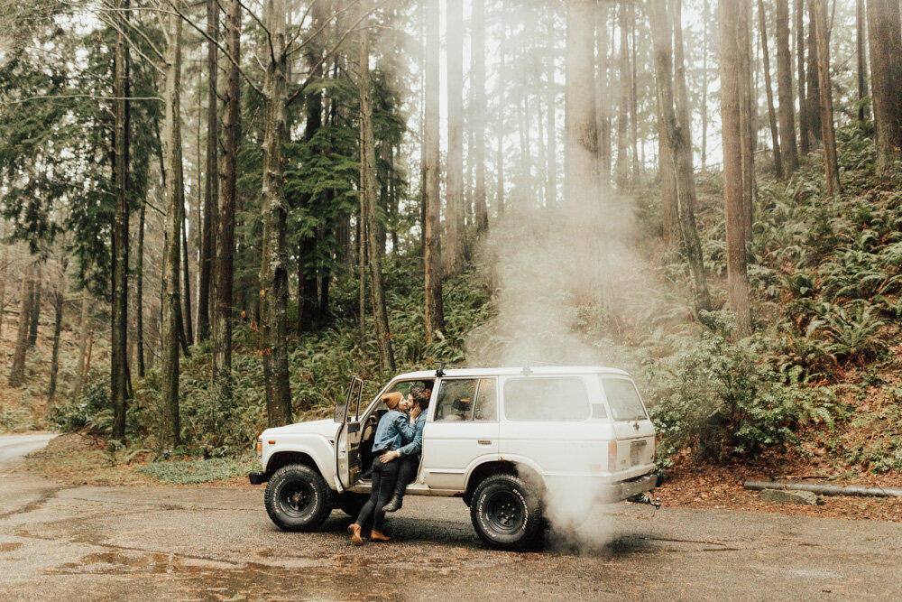 couple kissing in washington forest in jeep