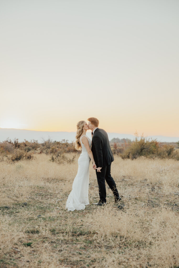 sunset photography bride and groom wedding day kiss