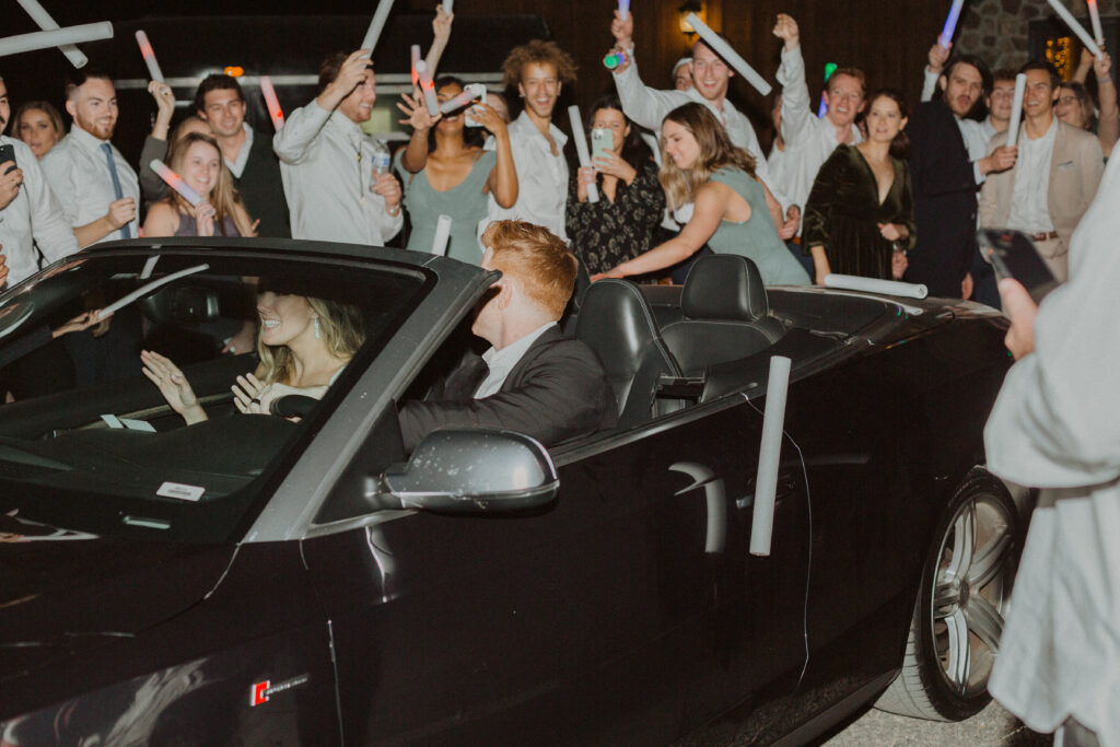 bride & groom car exit glow sticks wedding guests