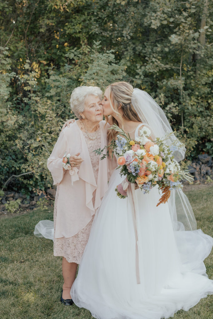 grandma kiss with bride wedding day