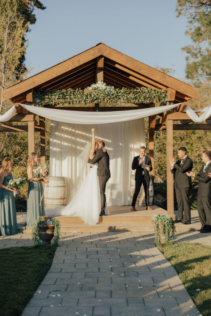 bride and groom kiss wedding ceremony outside garden venue