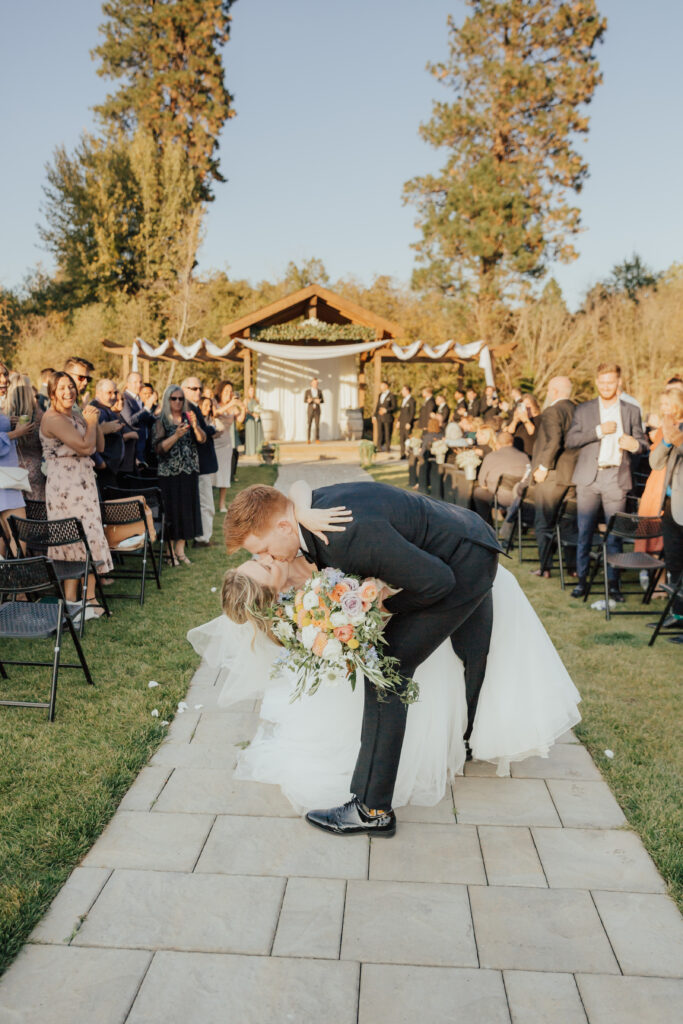 bride and groom dip kiss wedding ceremony