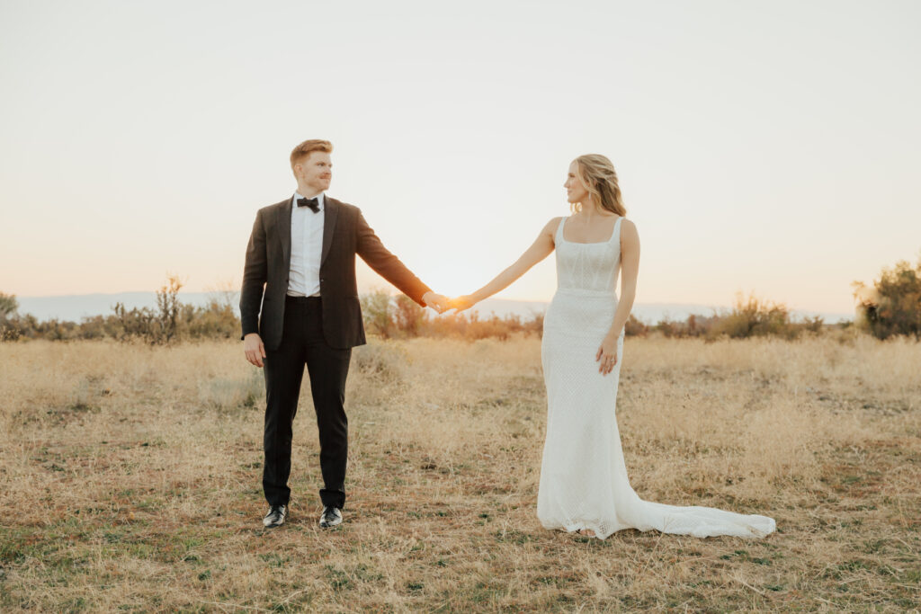 sunset photography bride and groom wedding day holding hands wedding dress suit