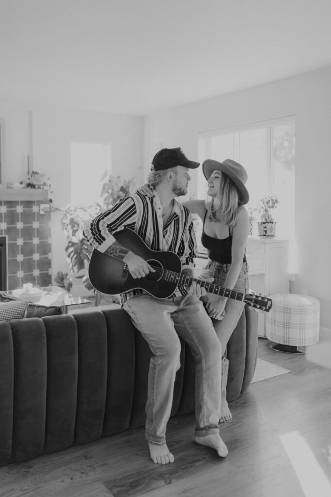 In home couple engagement photoshoot boyfriend playing guitar to fiance tacoma washington